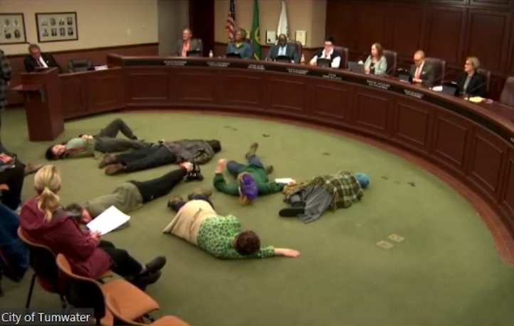 Six members of a youth climate group staged a die-in in front of city council for 22 minutes.